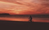 Велосипедист вечером на пляже